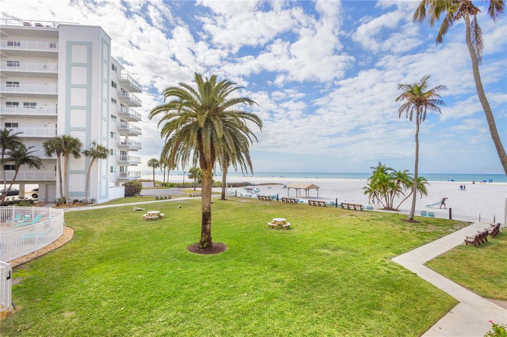5830 Midnight Pass Road, Unit T22 Sarasota, FL 34242 - Photo 32 of 65 a swimming pool with lots of palm trees