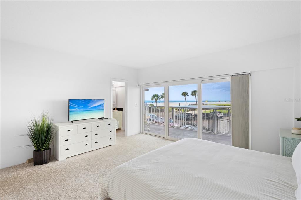 5830 Midnight Pass Road, Unit T22 Sarasota, FL 34242 - Photo 5 of 65 a bedroom with a bed and a view of kitchen