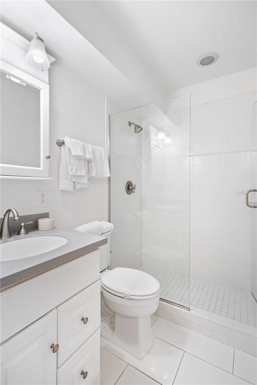 5830 Midnight Pass Road, Unit T22 Sarasota, FL 34242 - Photo 6 of 65 a bathroom with a granite countertop sink a toilet and a mirror