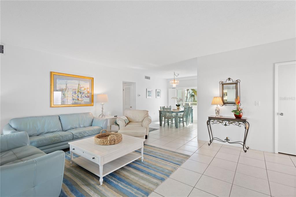 5830 Midnight Pass Road, Unit T22 Sarasota, FL 34242 - Photo 10 of 65 a living room with furniture and wooden floor