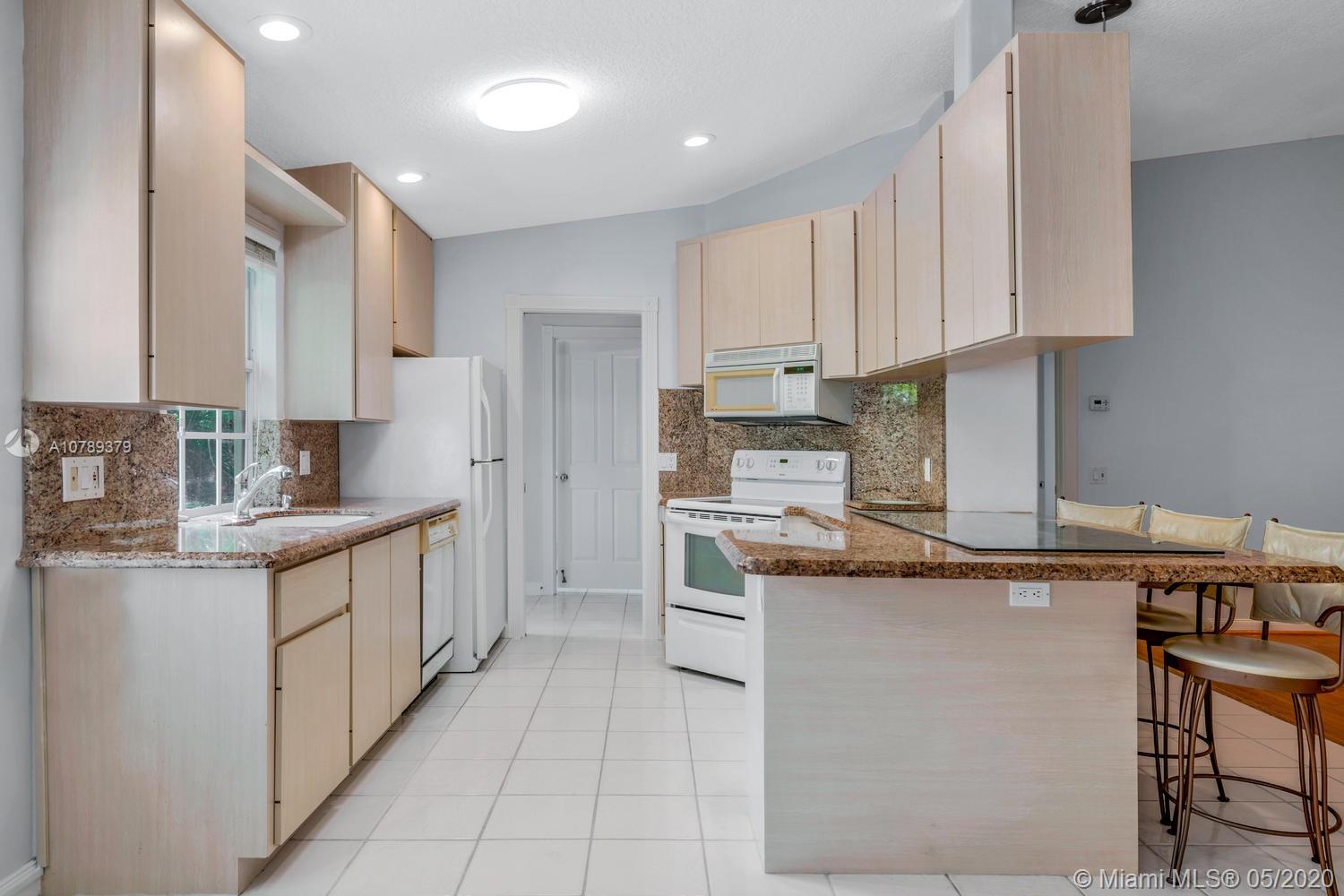 4047 Grove Point Road Palm Beach Gardens, FL 33410 - Photo 5 of 26 Kitchen view from dining area