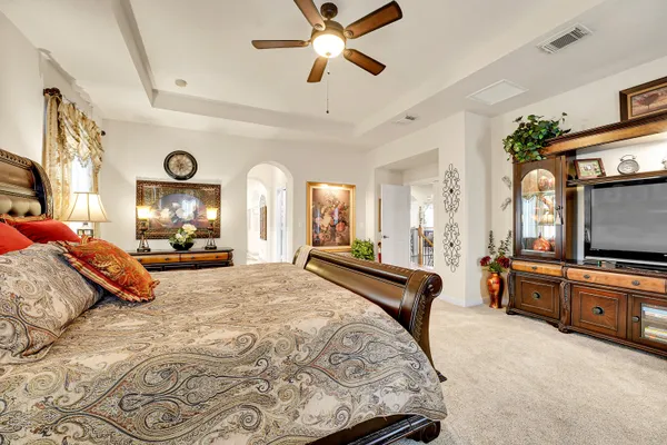 a bedroom with a bed and a chandelier