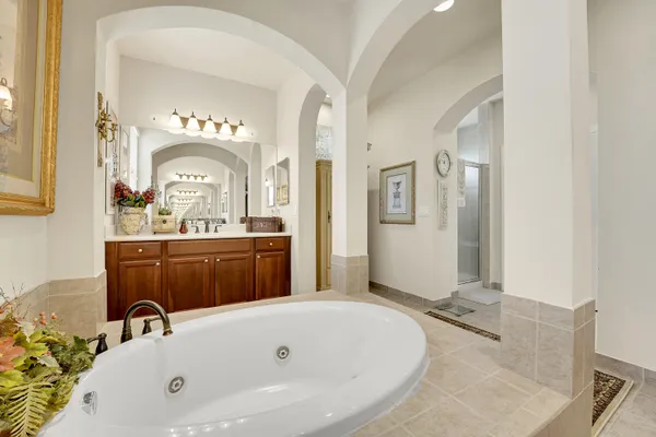 a bathroom with a granite countertop toilet sink and mirror