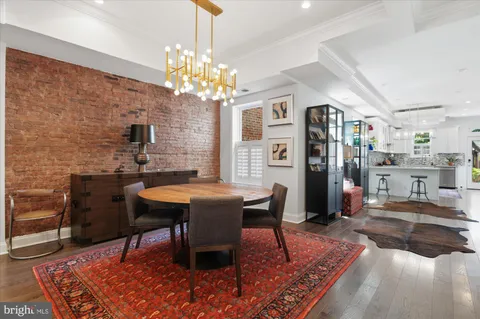 a view of a dining room with furniture wooden floor and a chandelier