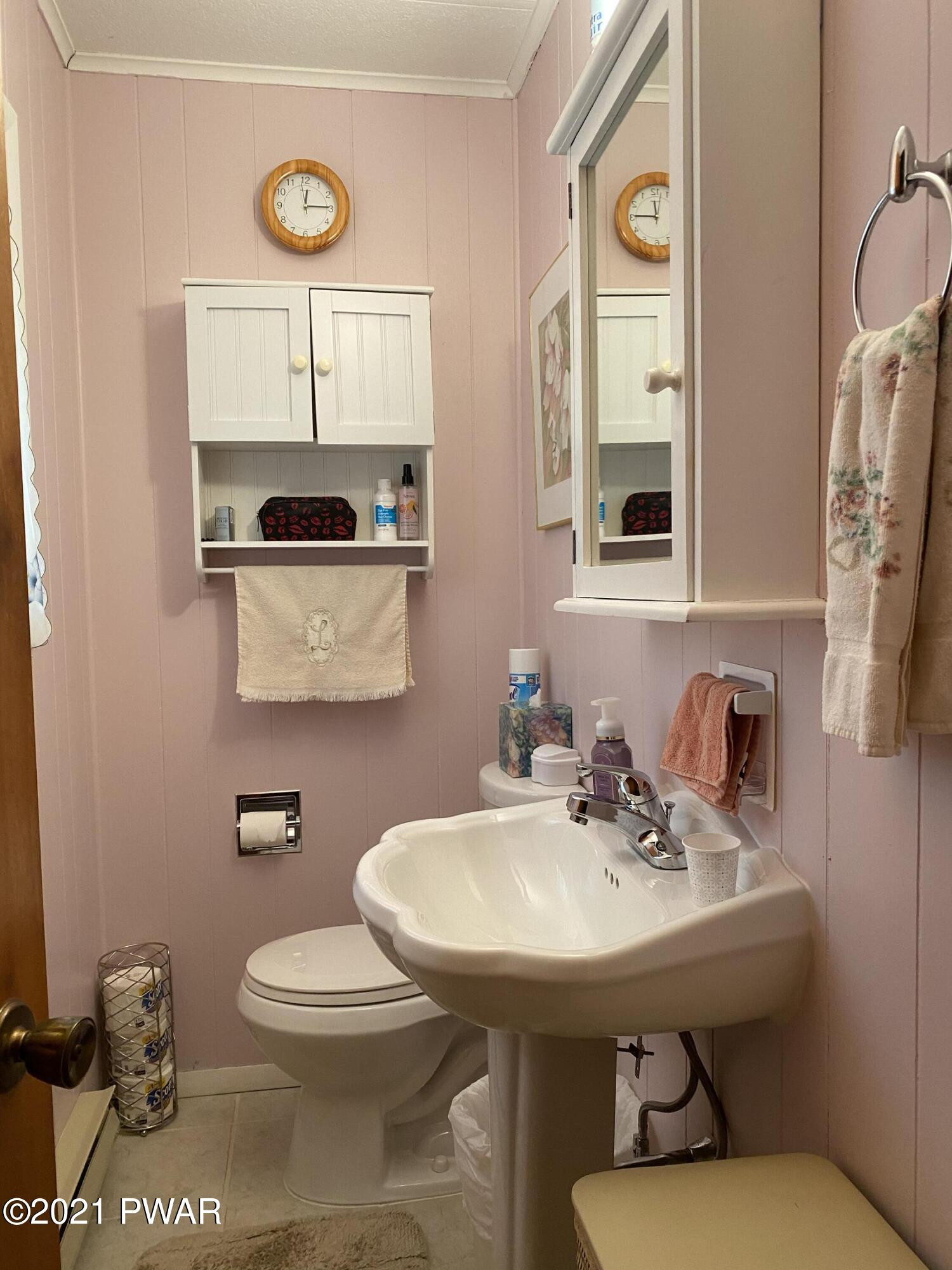125 Maple Ridge Drive Hawley, PA 18428 - Photo 15 of 49 a bathroom with a sink a toilet and mirror