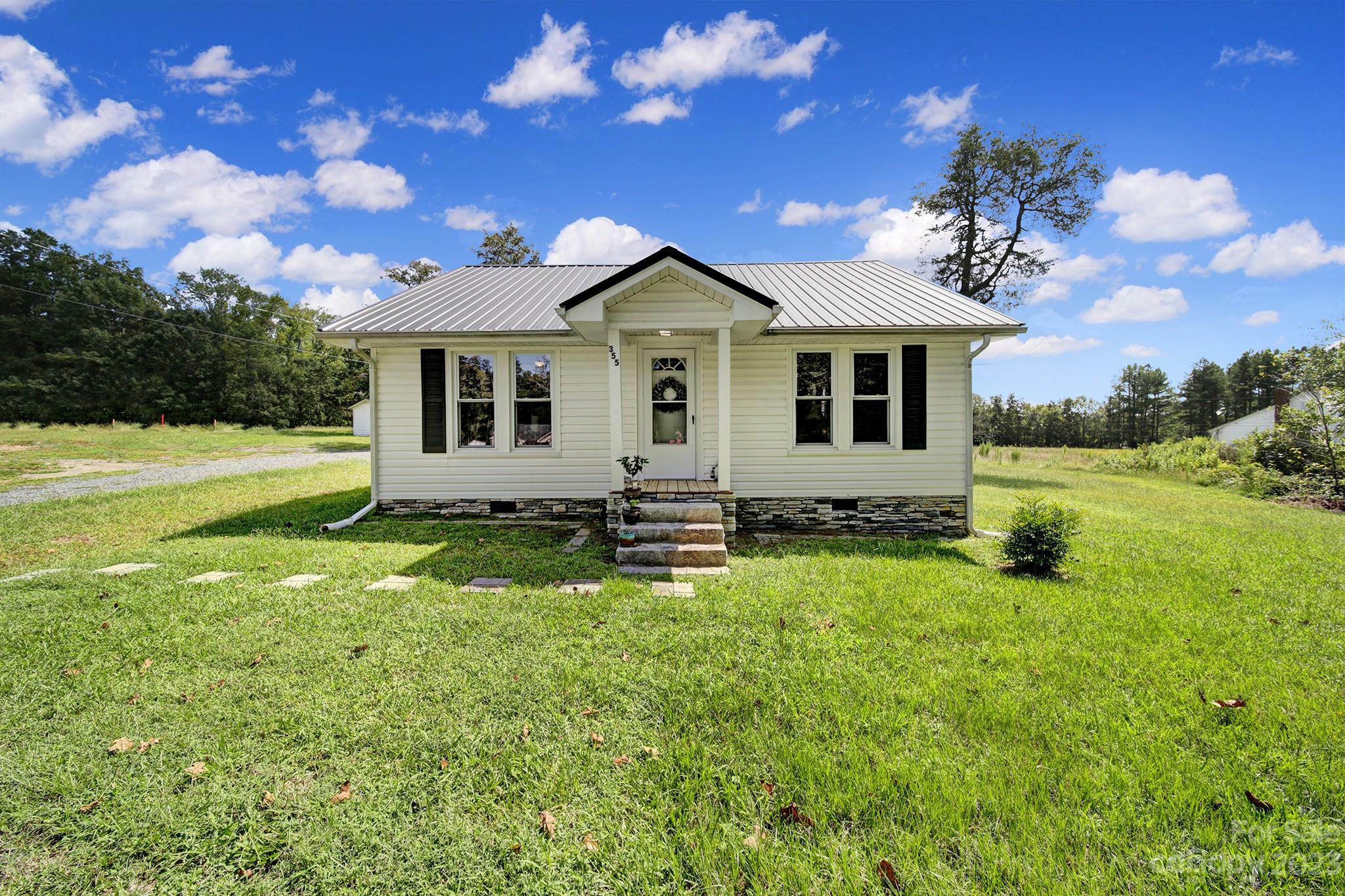 355 Walker Road Mount Pleasant, NC 28124 - Photo 1 of 33 a house view with a garden space