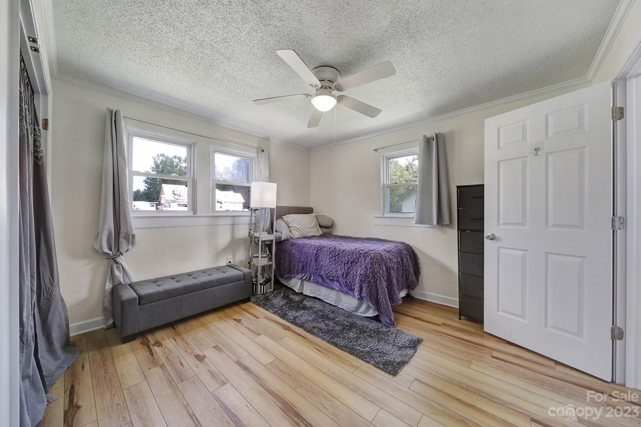 355 Walker Road Mount Pleasant, NC 28124 - Photo 11 of 33 a spacious bedroom with a bed and wooden floor