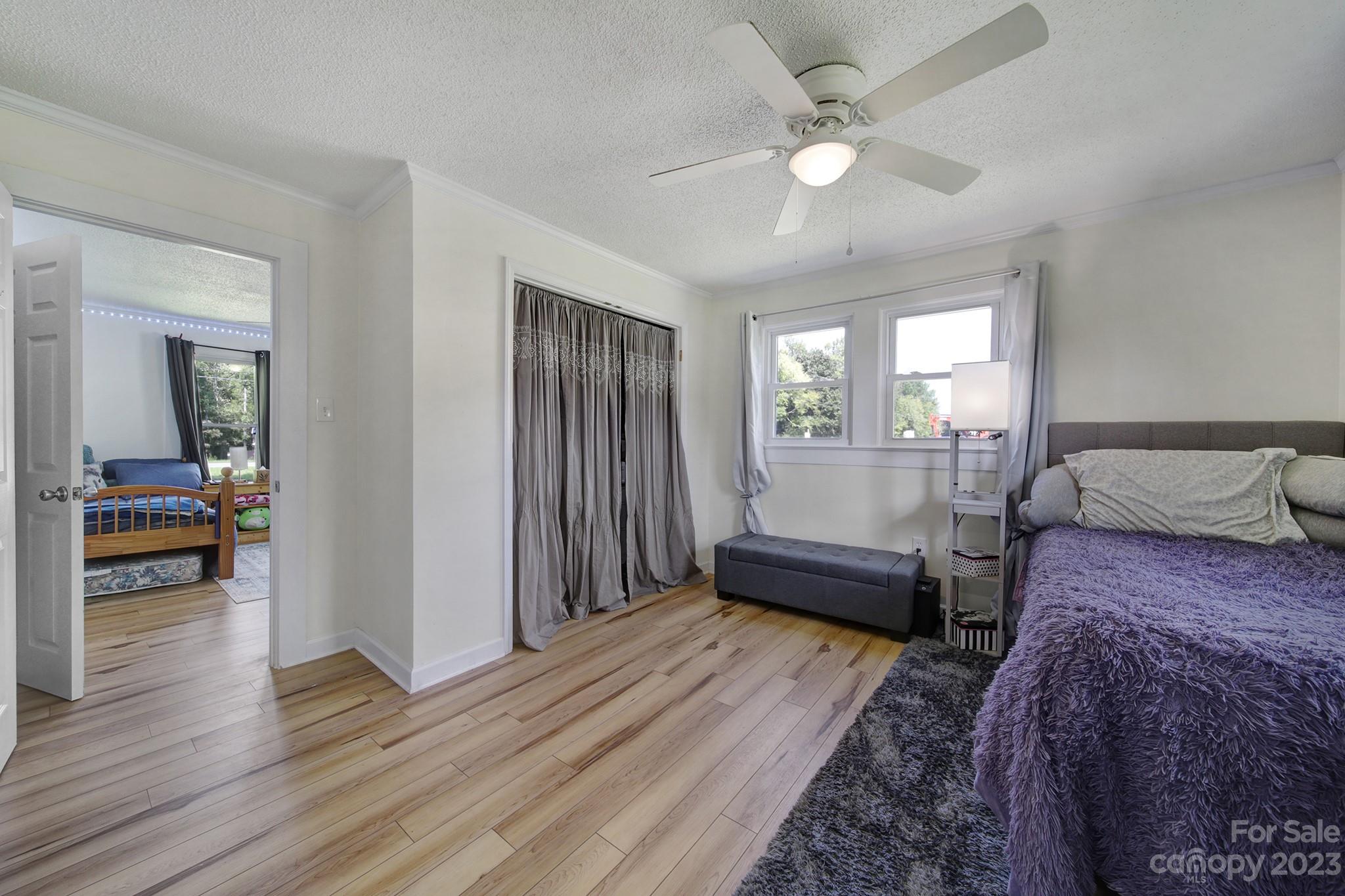 355 Walker Road Mount Pleasant, NC 28124 - Photo 12 of 33 a bedroom with a bed and a chandelier