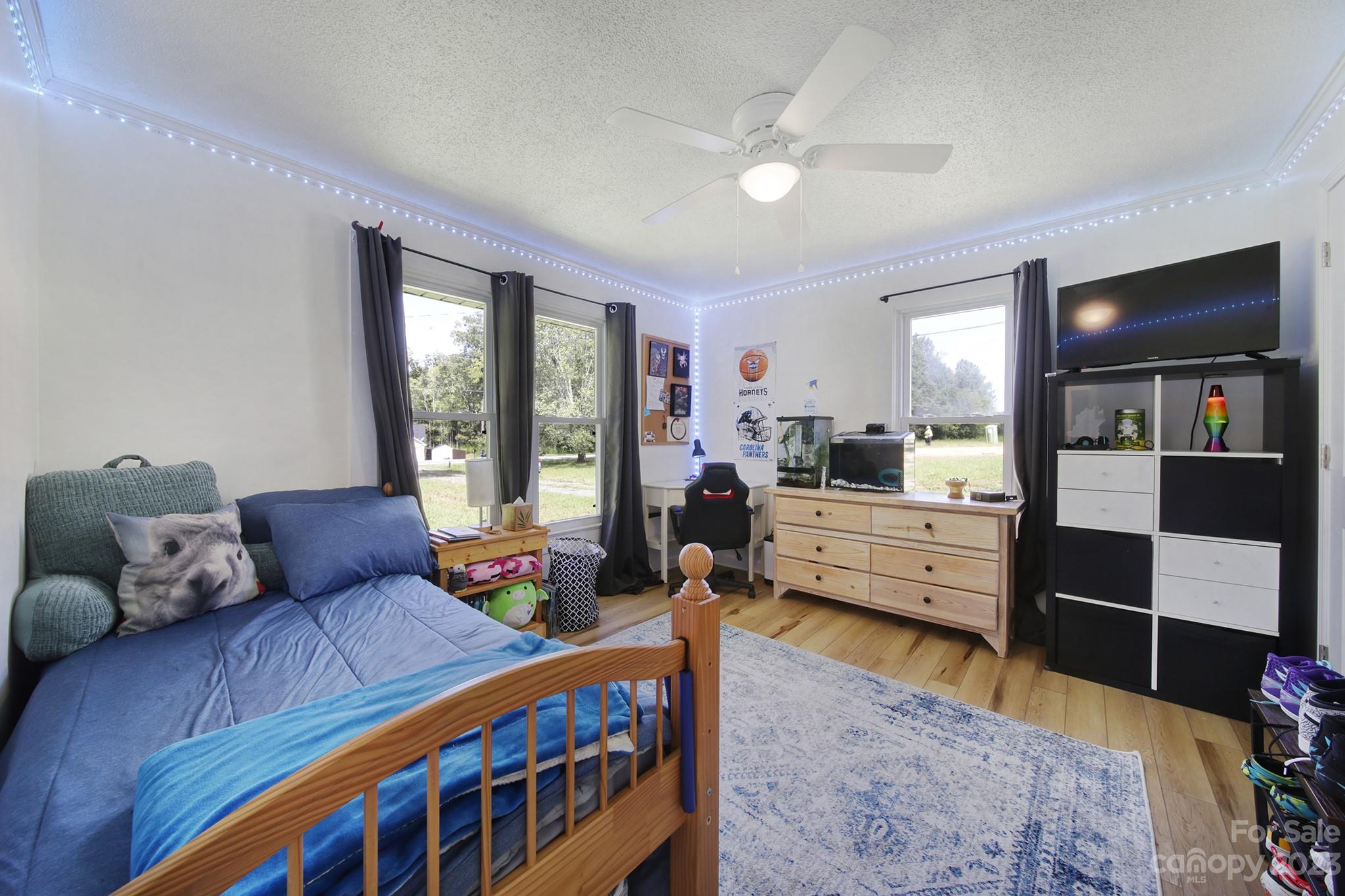 355 Walker Road Mount Pleasant, NC 28124 - Photo 16 of 33 a bedroom with furniture and a wooden floor