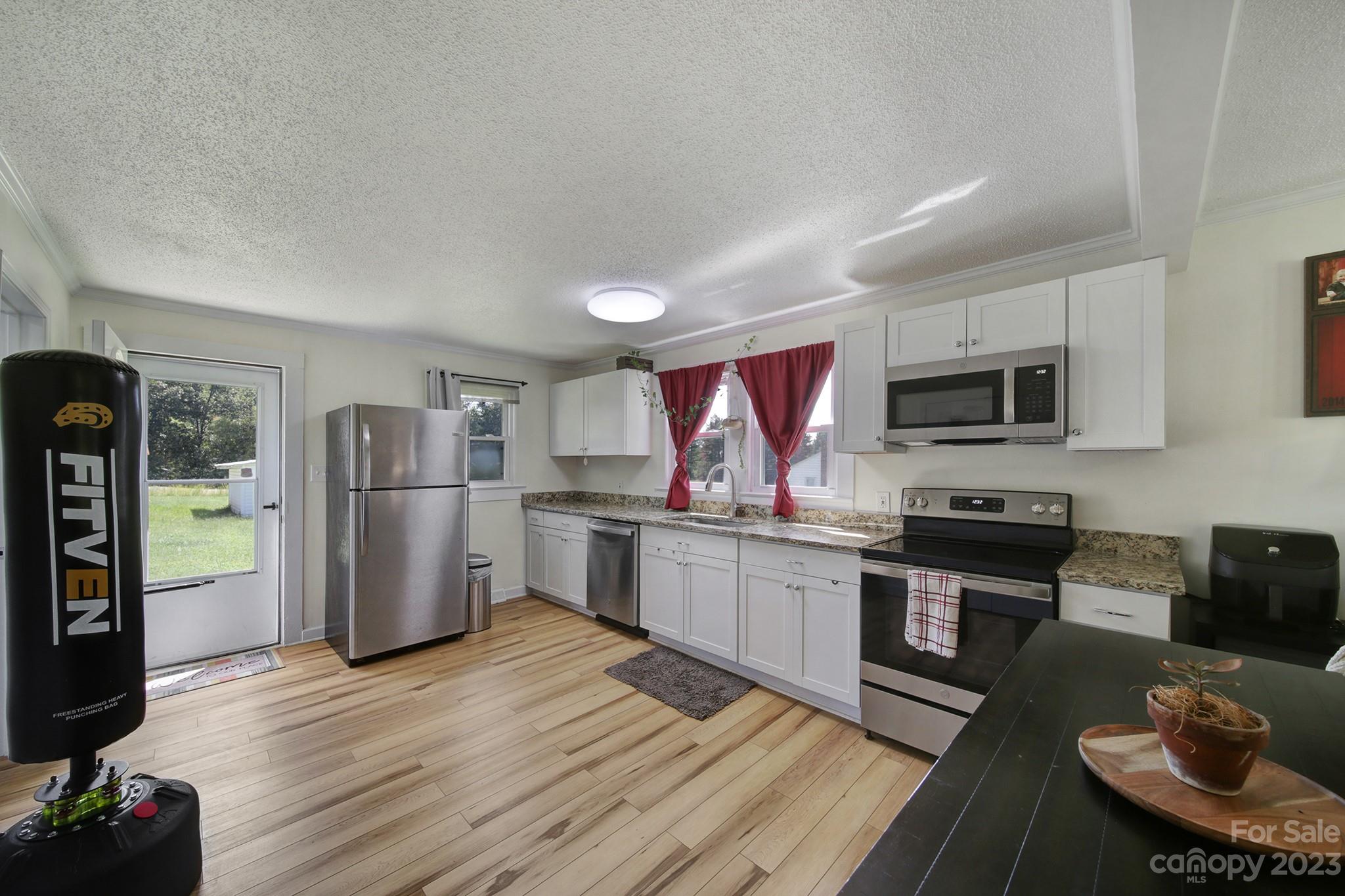 355 Walker Road Mount Pleasant, NC 28124 - Photo 6 of 33 a kitchen with a refrigerator microwave and stove top oven