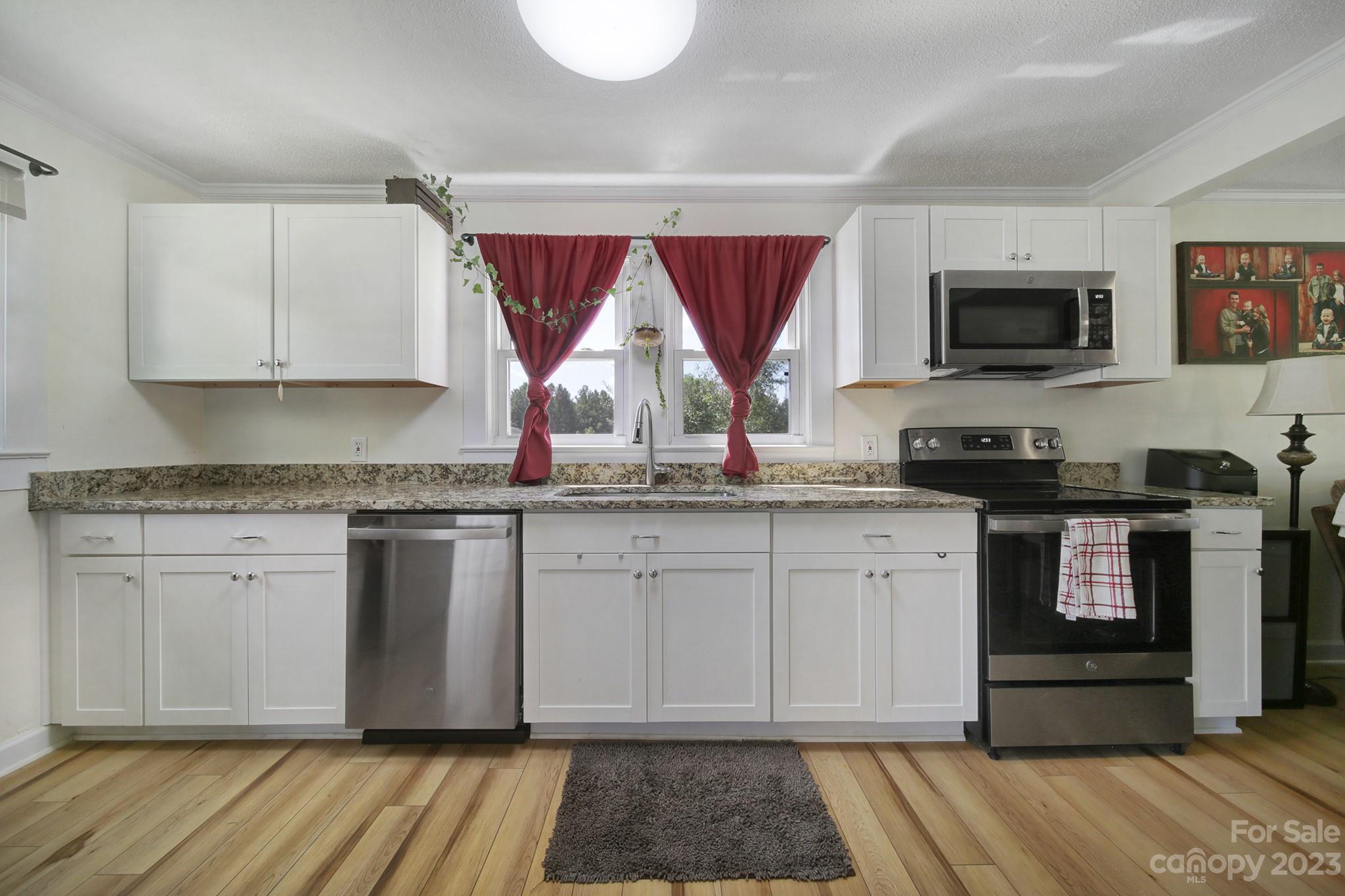 355 Walker Road Mount Pleasant, NC 28124 - Photo 7 of 33 a kitchen with granite countertop a refrigerator and a stove top oven