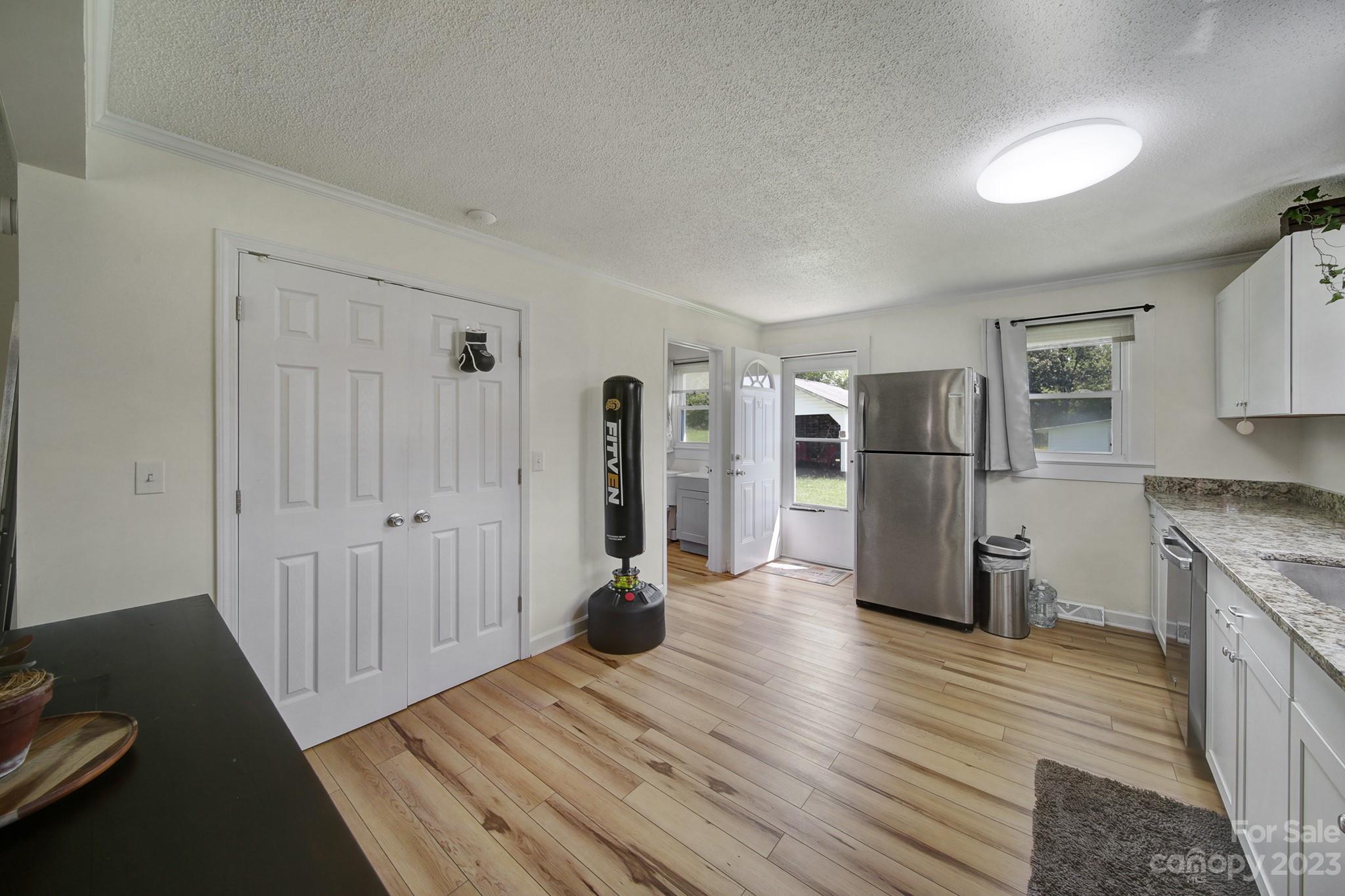 355 Walker Road Mount Pleasant, NC 28124 - Photo 8 of 33 a view of a kitchen with refrigerator and wooden floor