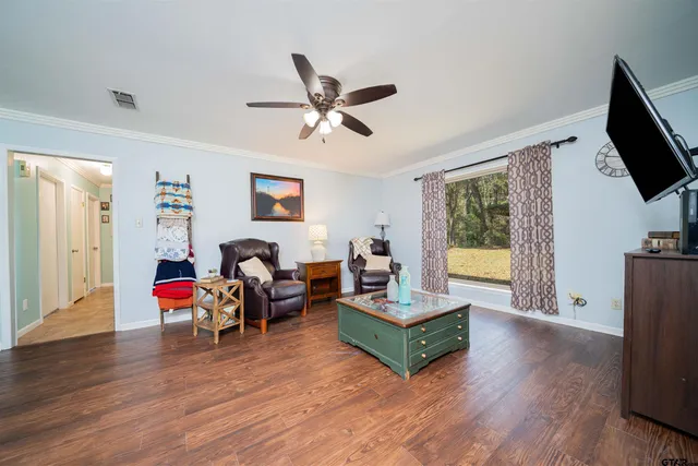 a living room with fireplace furniture and a flat screen tv
