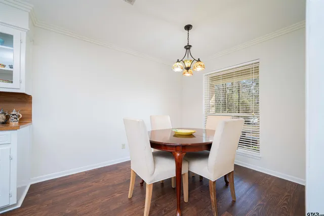 a view of a dining room with furniture wooden floor and chandelier