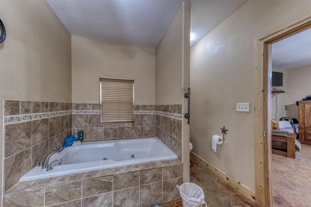 a bathroom with double vanity and a mirror