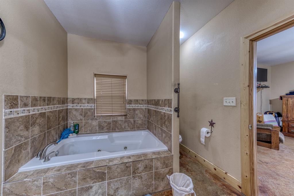 2975 North Fm 1702 Hamilton, TX 76531 - Photo 10 of 35 a bath tub sitting next to a bathroom