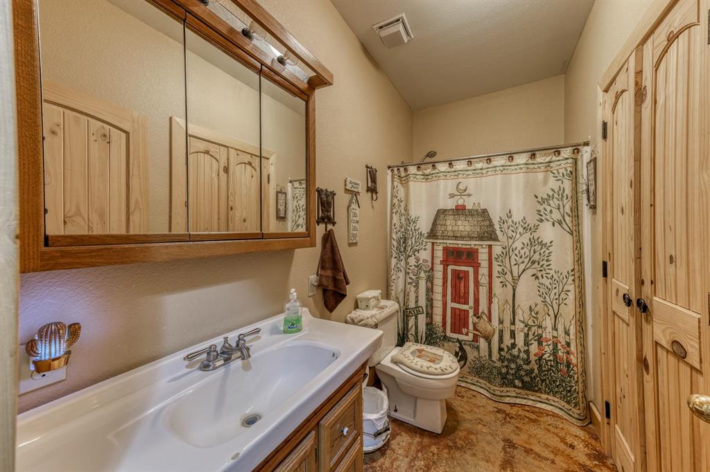 2975 North Fm 1702 Hamilton, TX 76531 - Photo 16 of 35 a bathroom with a sink a toilet and shower