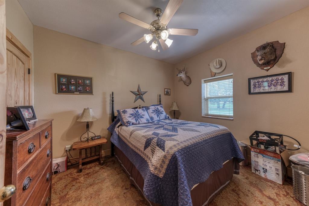 2975 North Fm 1702 Hamilton, TX 76531 - Photo 17 of 35 a bedroom with a bed and a chandelier