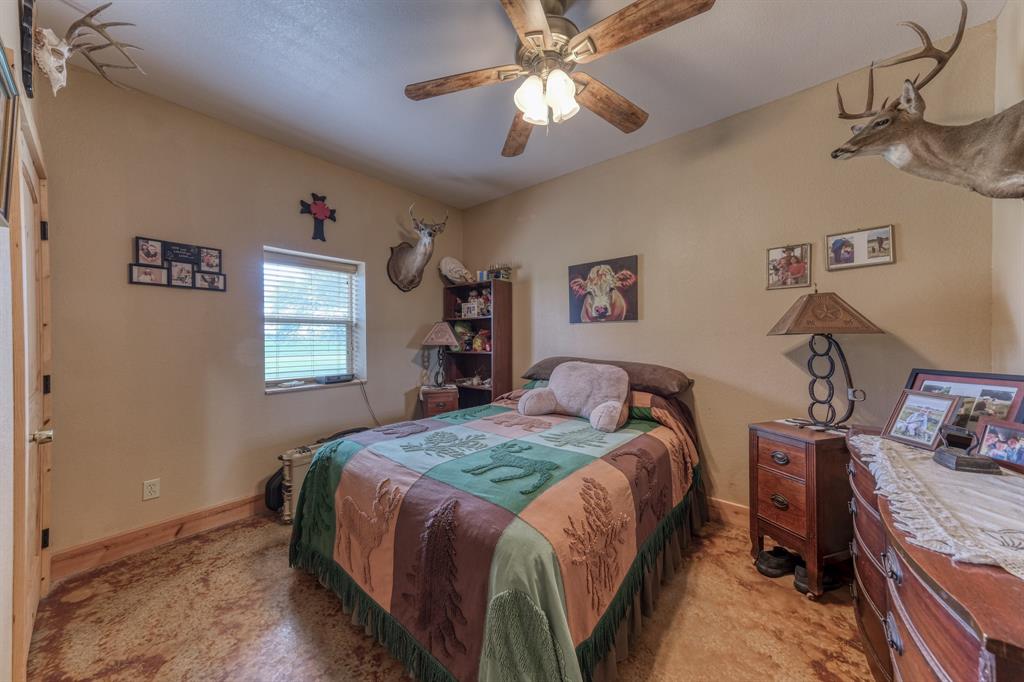 2975 North Fm 1702 Hamilton, TX 76531 - Photo 18 of 35 a bedroom with a bed and a chandelier
