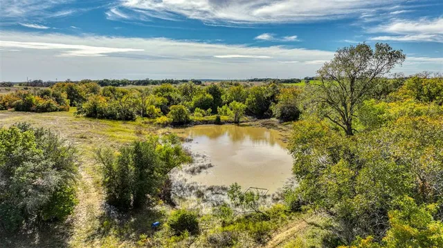 a view of a lake with a yard