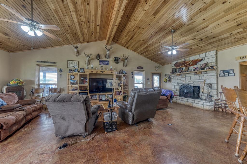 2975 North Fm 1702 Hamilton, TX 76531 - Photo 27 of 35 a living room with furniture a fireplace and a chandelier