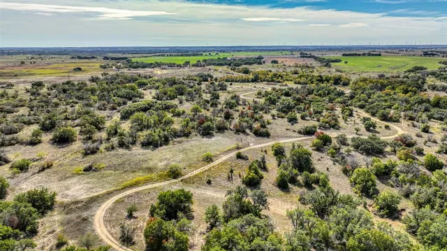 a view of a yard with wooden fence