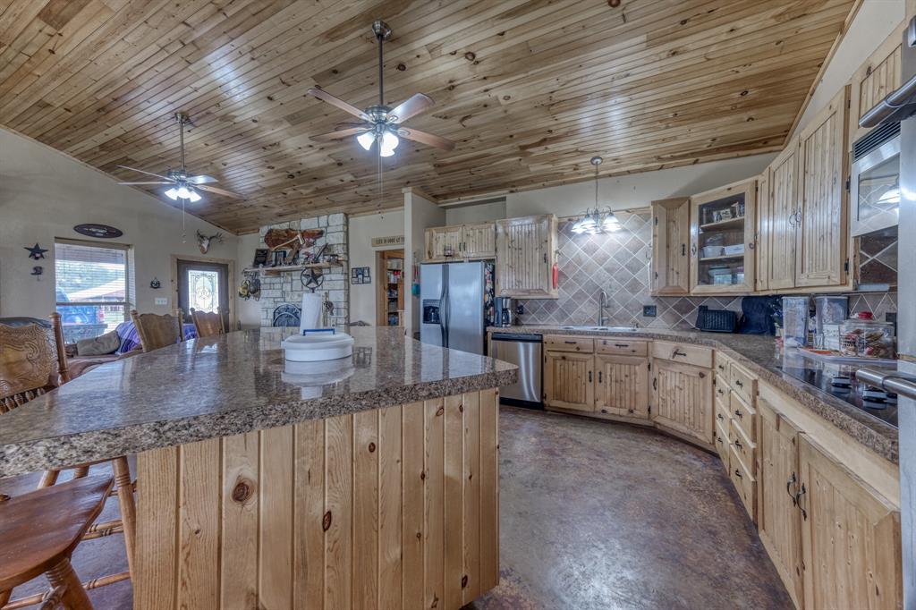 2975 North Fm 1702 Hamilton, TX 76531 - Photo 6 of 35 a kitchen with stainless steel appliances granite countertop a sink a stove and cabinets