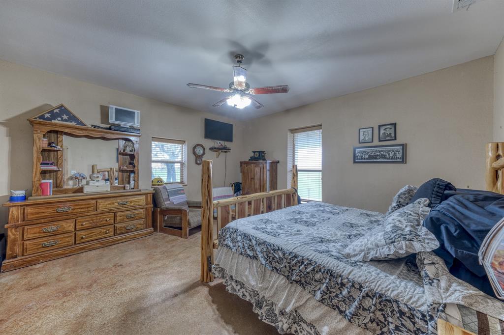 2975 North Fm 1702 Hamilton, TX 76531 - Photo 7 of 35 a bedroom with a large bed and a chandelier