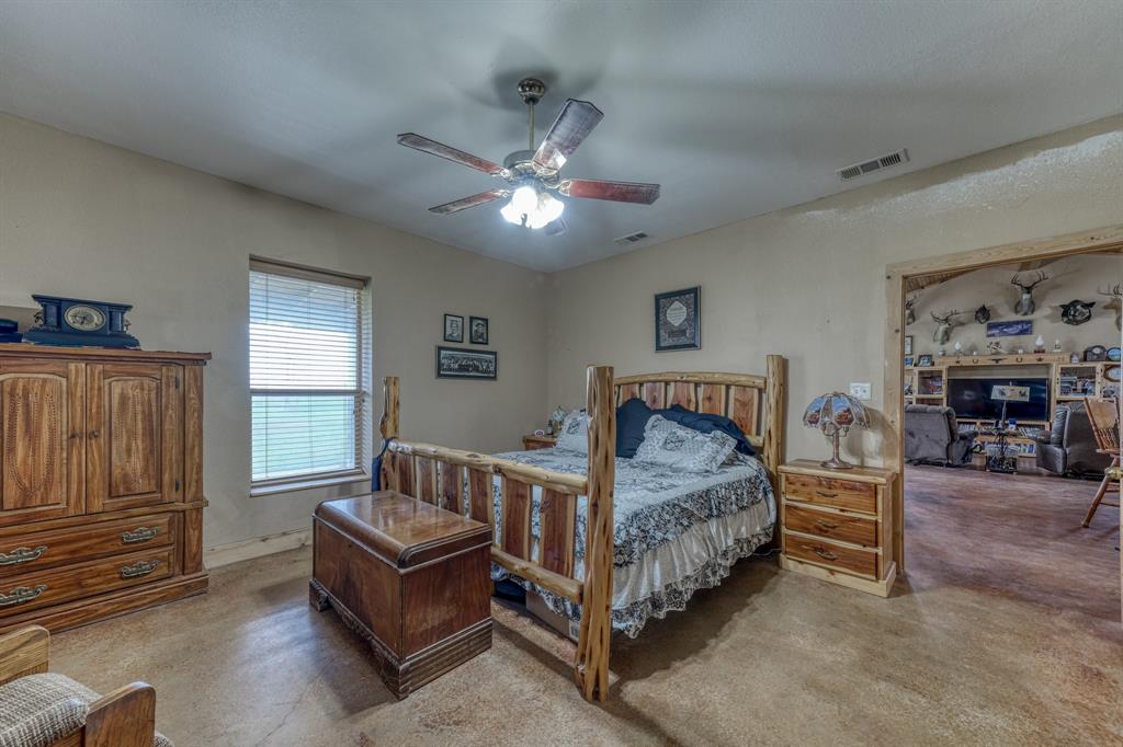 2975 North Fm 1702 Hamilton, TX 76531 - Photo 8 of 35 a bedroom with a bed and a chandelier