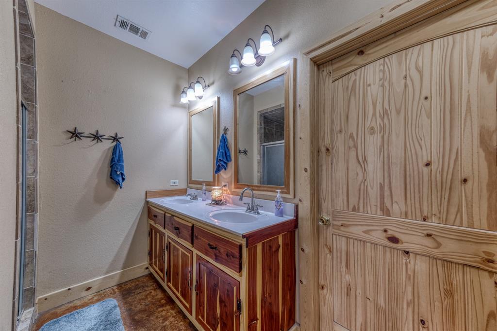 2975 North Fm 1702 Hamilton, TX 76531 - Photo 9 of 35 a bathroom with double vanity and a mirror