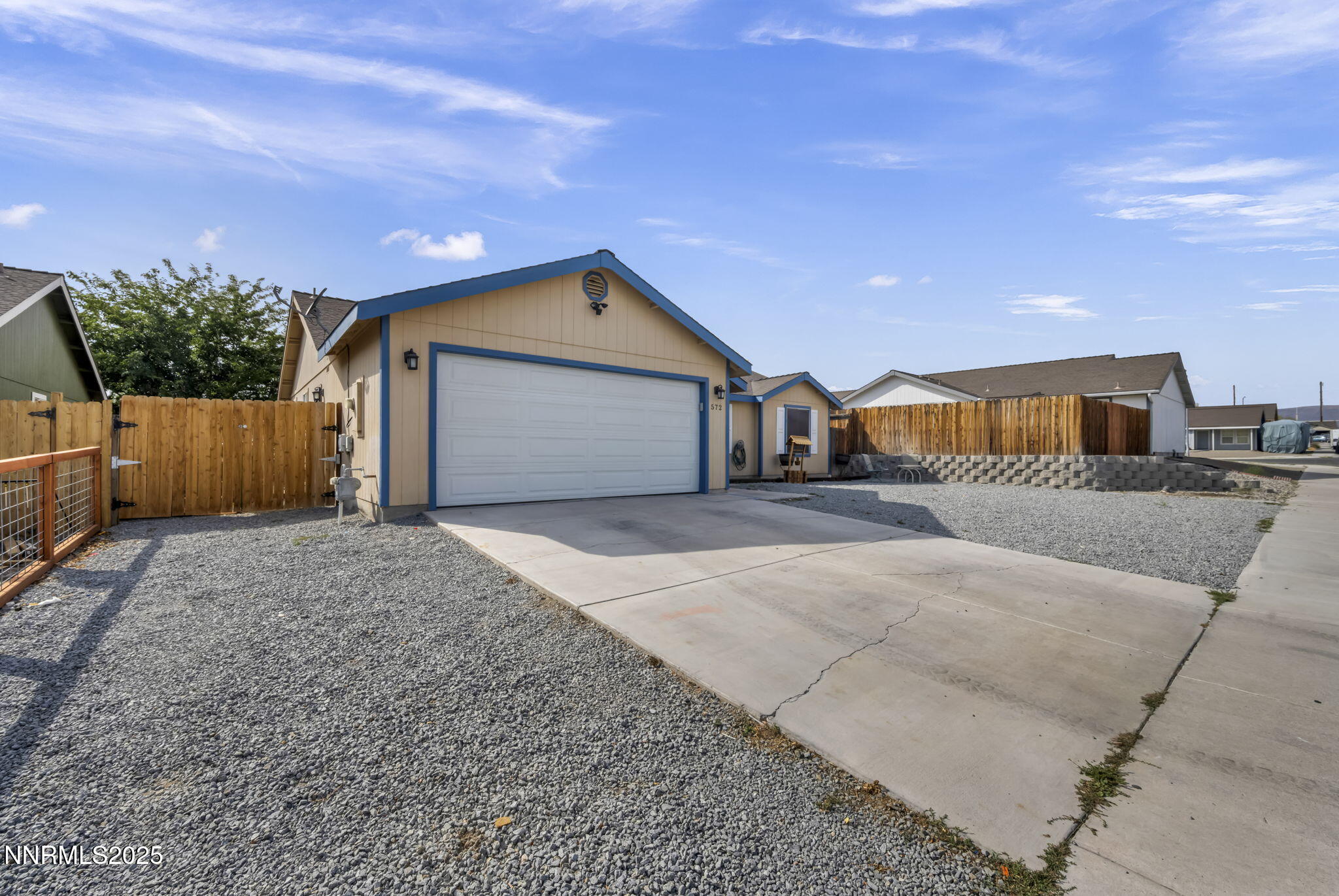 572 Spur Way Fernley, NV 89408 - Photo 3 of 48 a front view of a house with a yard and garage