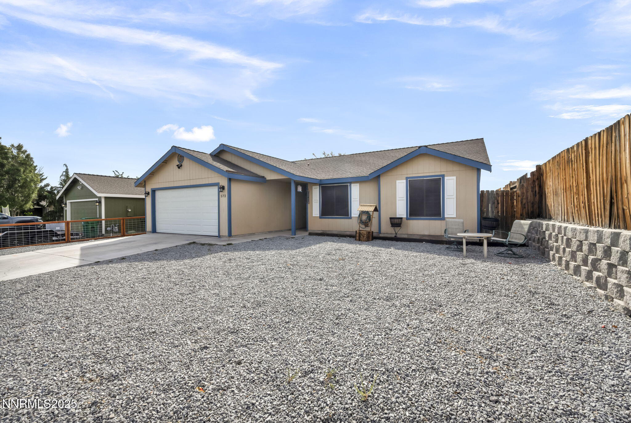 572 Spur Way Fernley, NV 89408 - Photo 4 of 48 a front view of a house with a yard and garage