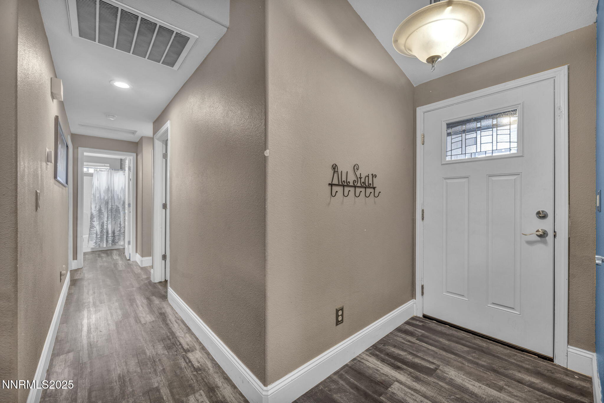 572 Spur Way Fernley, NV 89408 - Photo 5 of 48 a view of a hallway with wooden floor