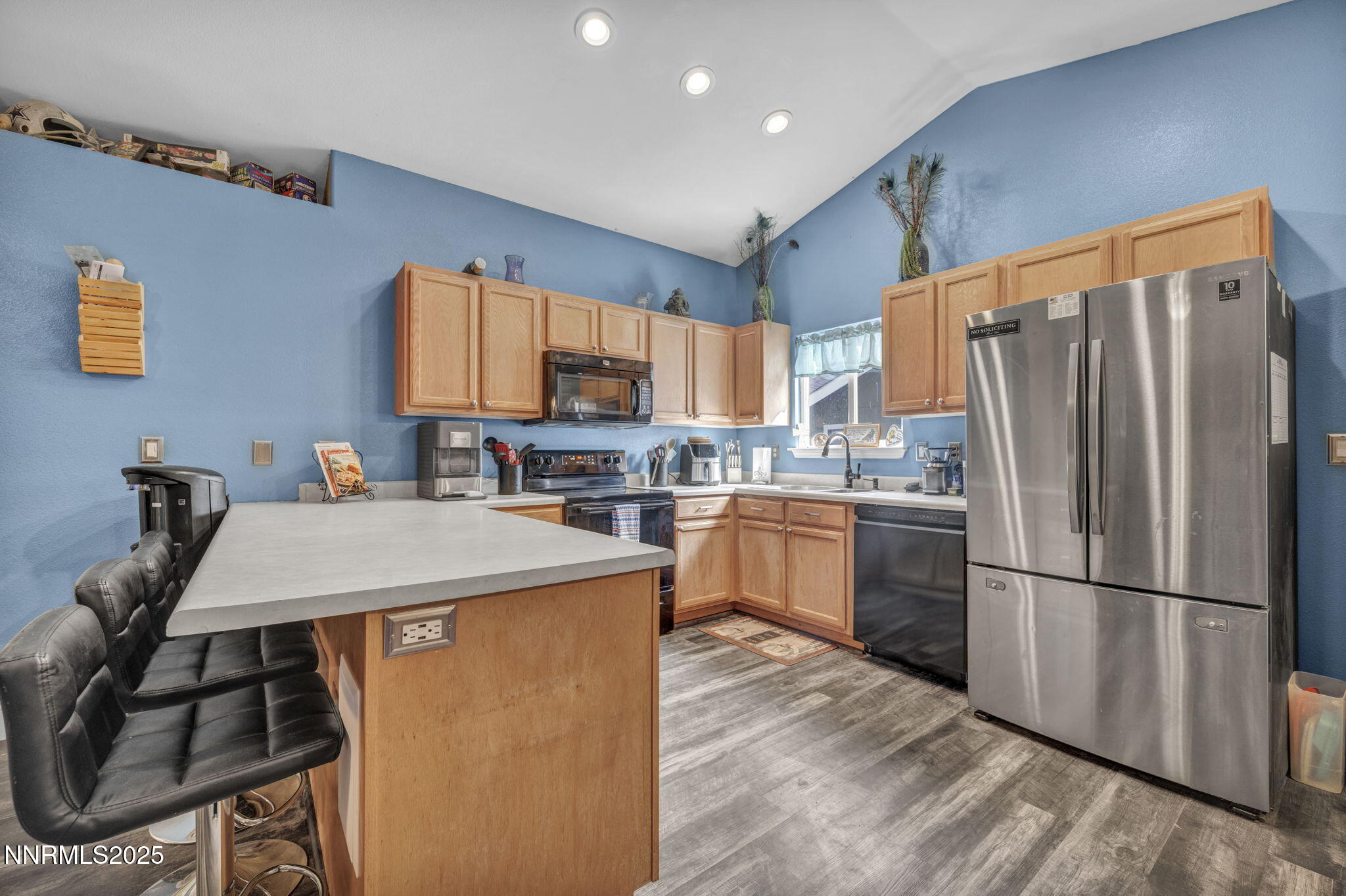572 Spur Way Fernley, NV 89408 - Photo 6 of 48 a kitchen with stainless steel appliances a refrigerator stove microwave and sink
