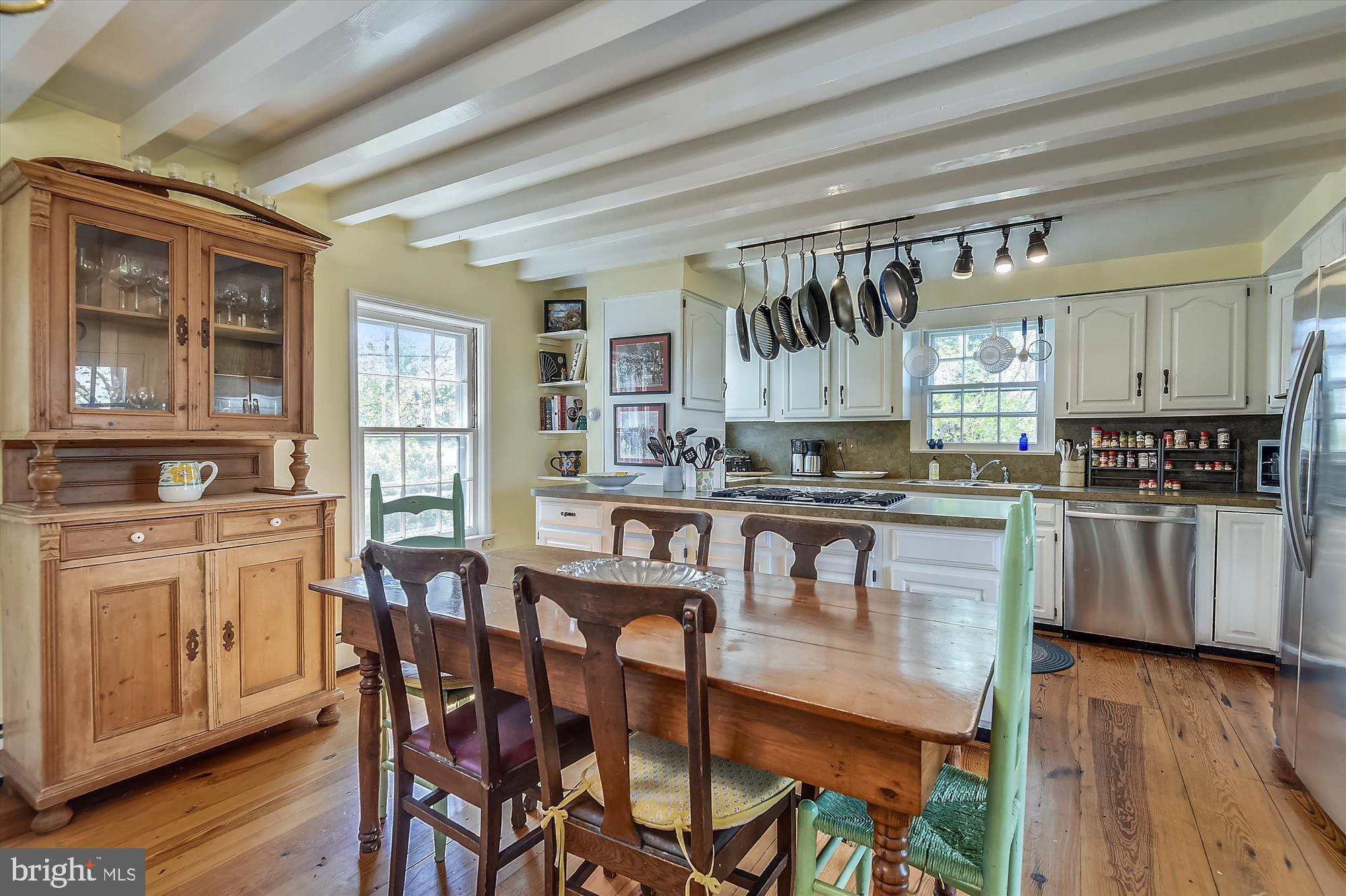 20209 St Louis Road Purcellville, VA 20132 - Photo 12 of 62 a kitchen with stainless steel appliances granite countertop a stove a sink dishwasher a dining table and chairs with wooden floor