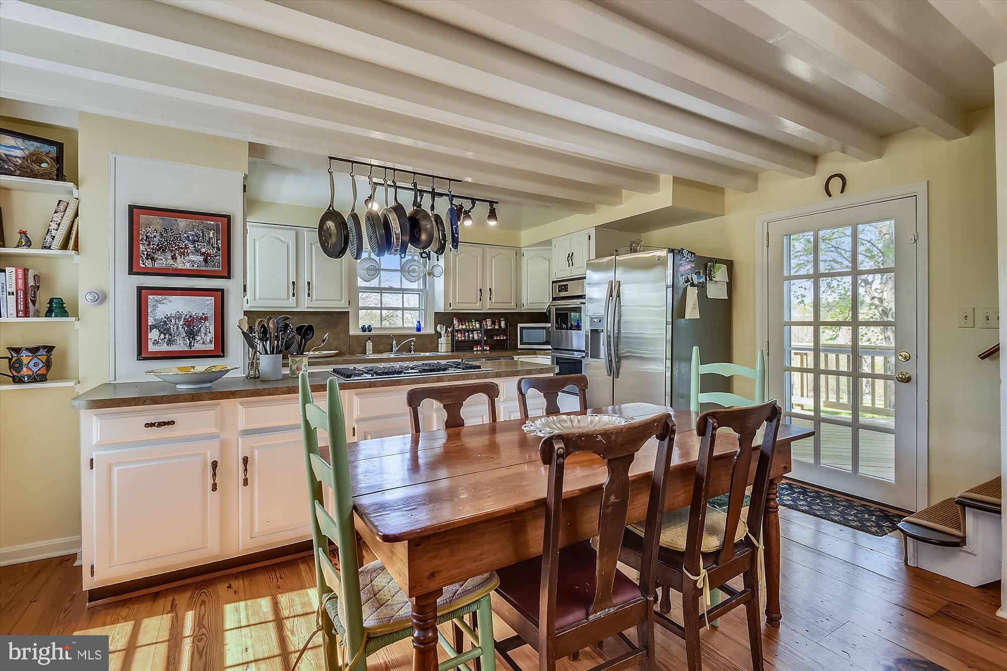 20209 St Louis Road Purcellville, VA 20132 - Photo 14 of 62 a kitchen with stainless steel appliances kitchen island granite countertop a dining table chairs and a refrigerator