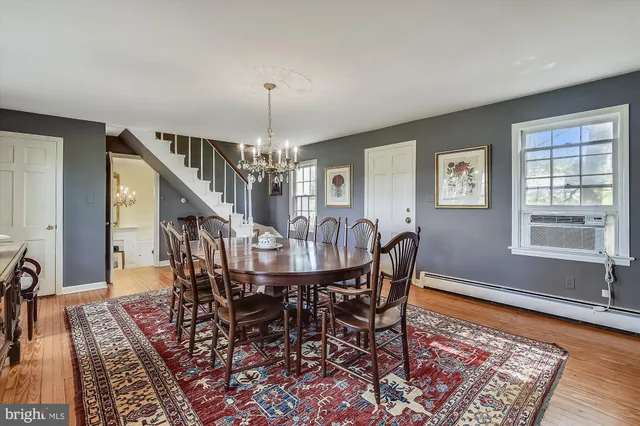 a view of a dining room with furniture a chandelier and wooden floor