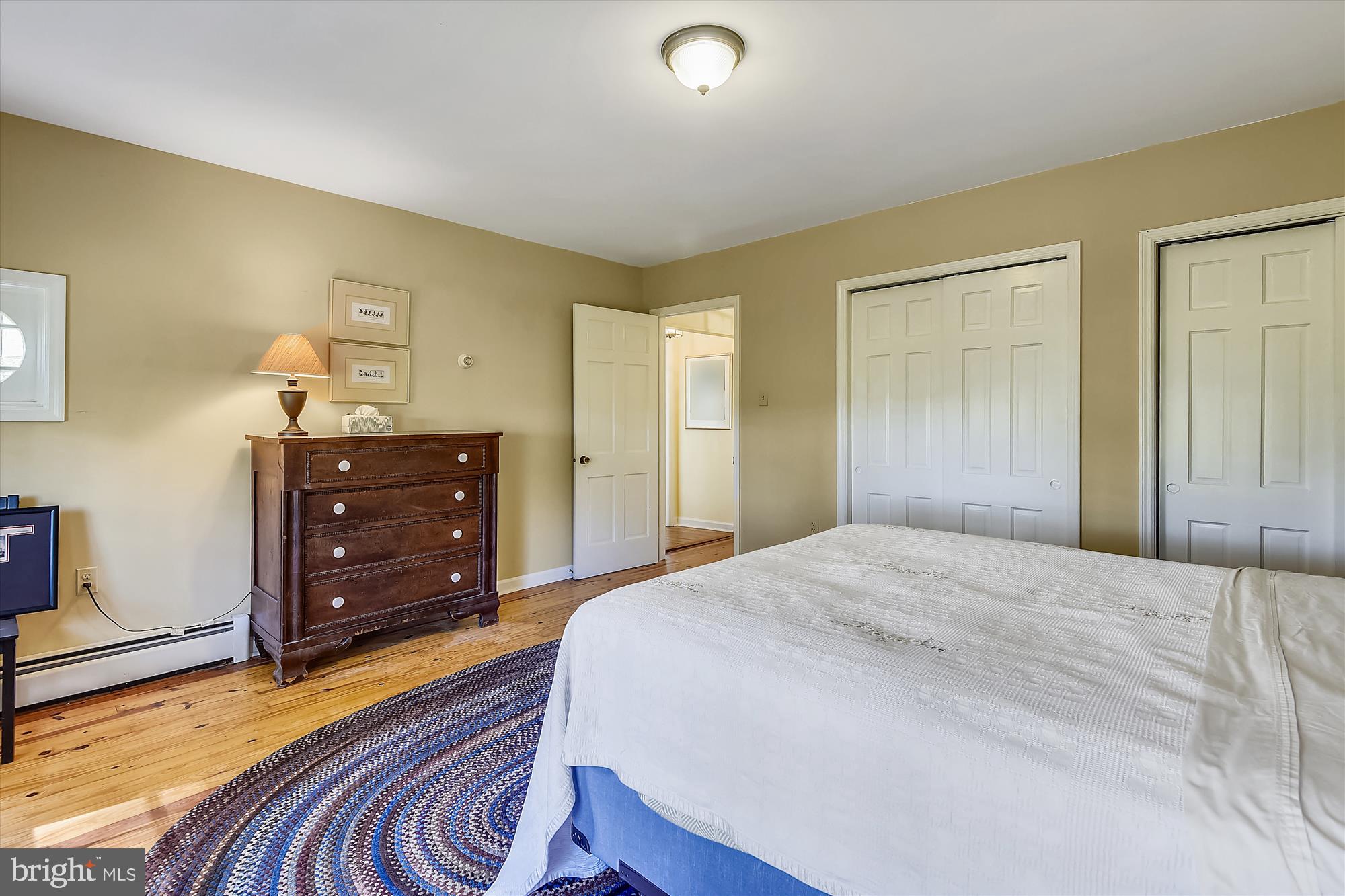 20209 St Louis Road Purcellville, VA 20132 - Photo 26 of 62 a bedroom with a bed and a dresser