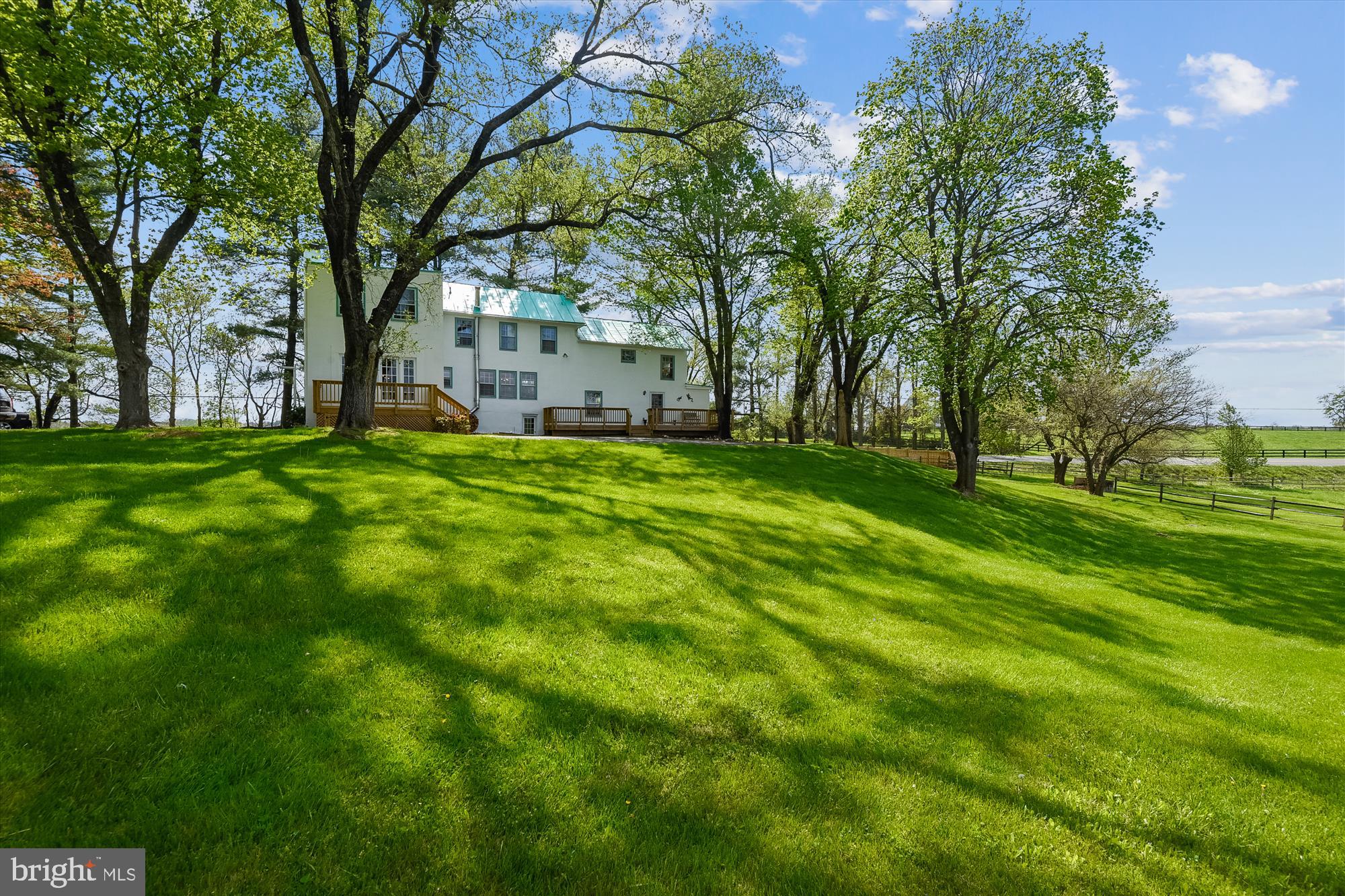 20209 St Louis Road Purcellville, VA 20132 - Photo 6 of 62 a backyard of a house with lots of green space and fountain