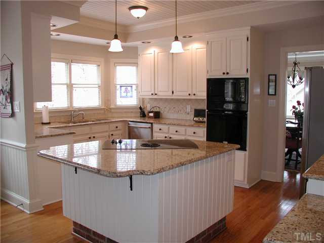 Spacious and updated kitchen (16.3'12.3') has an island with down-draft cooktop & built-in desk. All counters are fitted with granite counter tops. Wall oven with microwave and SS dishwasher. Tongue and groove wood ceiling too! Kitchen