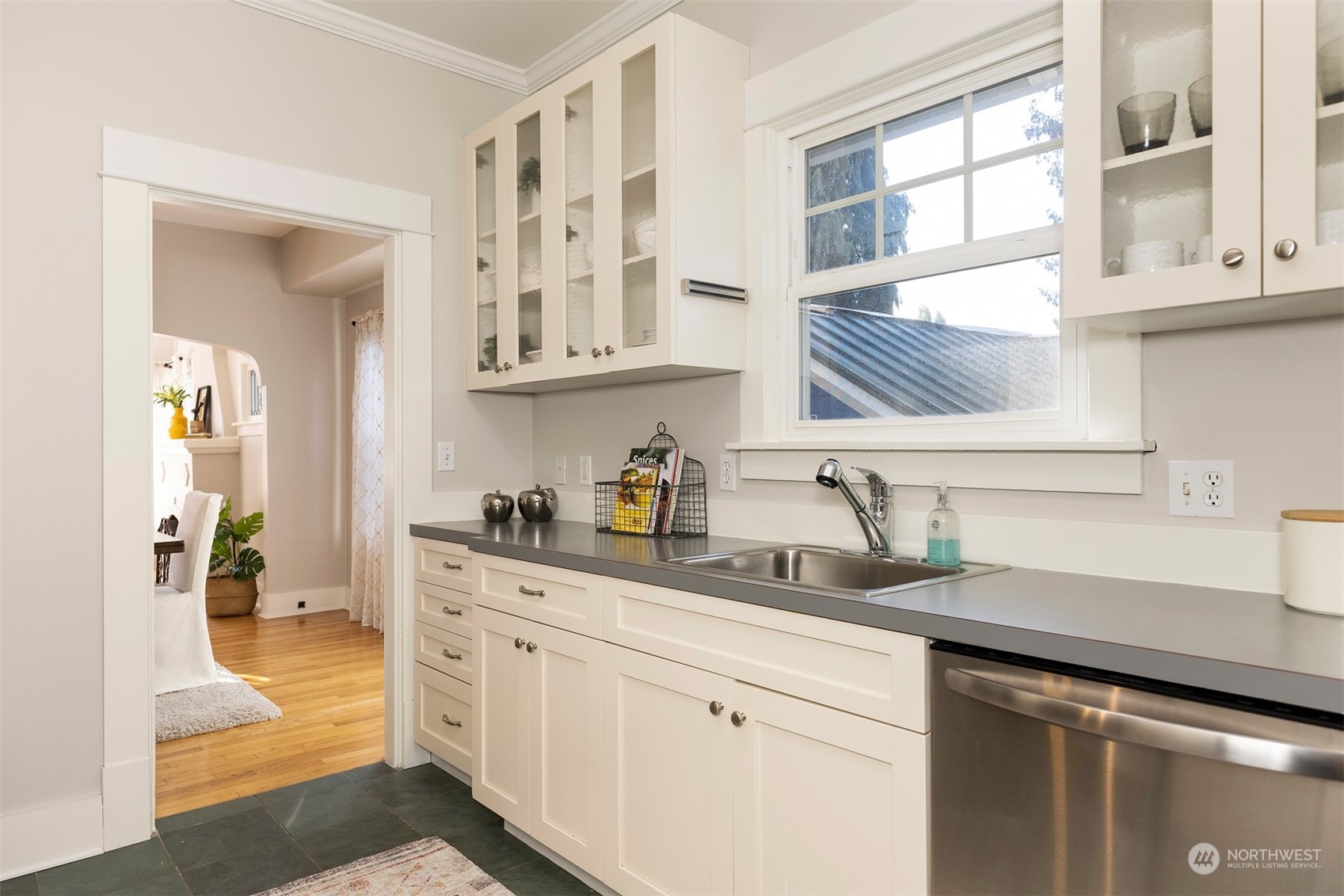 110 North 76th Street Seattle, WA 98103 - Photo 14 of 36 a kitchen with stainless steel appliances granite countertop a sink and cabinets