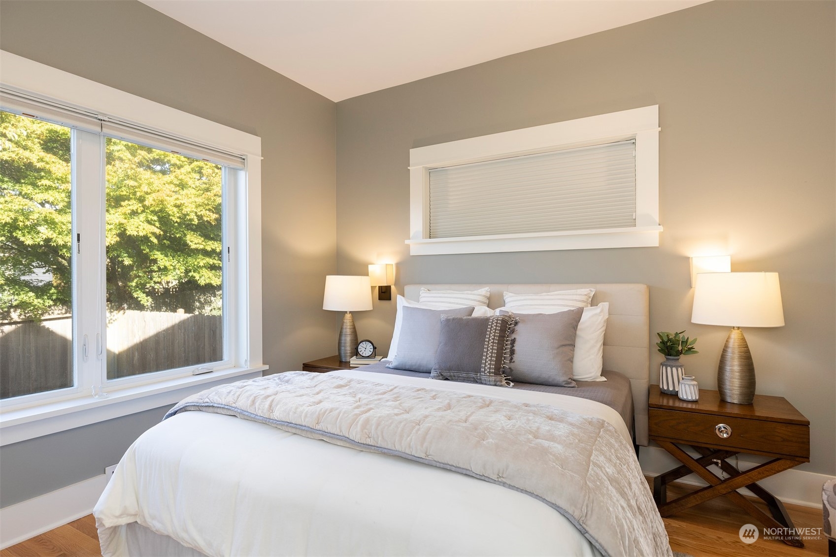 110 North 76th Street Seattle, WA 98103 - Photo 16 of 36 a bedroom with a bed and a lamp next to a window