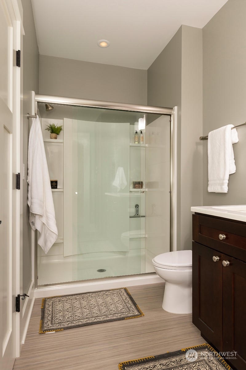 110 North 76th Street Seattle, WA 98103 - Photo 19 of 36 a bathroom with a shower a toilet and a sink