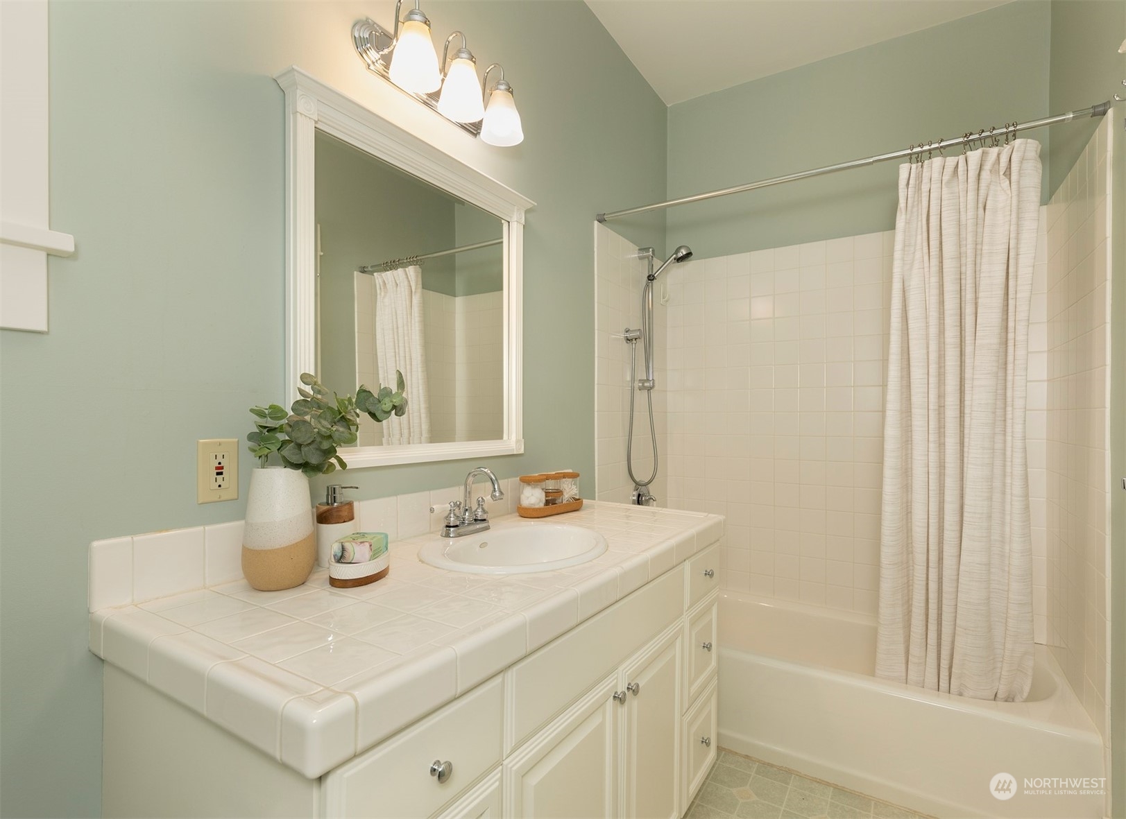 110 North 76th Street Seattle, WA 98103 - Photo 23 of 36 a bathroom with a sink a vanity and a mirror