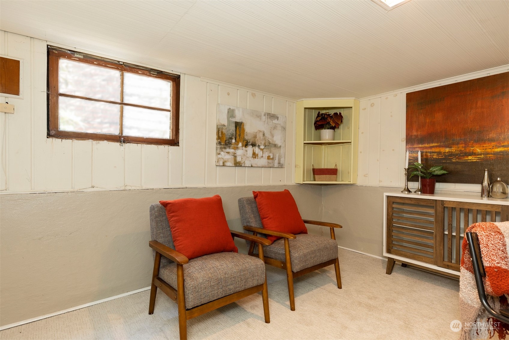 110 North 76th Street Seattle, WA 98103 - Photo 25 of 36 a blue chair sitting in front of a window