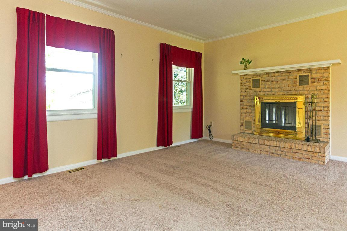 17615 Grace Road Hampstead, MD 21074 - Photo 3 of 30 a view of an empty room with window and fire place