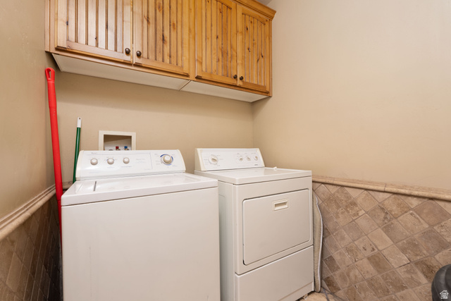 687 South 2080th Street East Springville, UT 84663 - Photo 36 of 149 Laundry area featuring upper wood-finish cabinetry, tile wainscoting, and neutral wall tones
