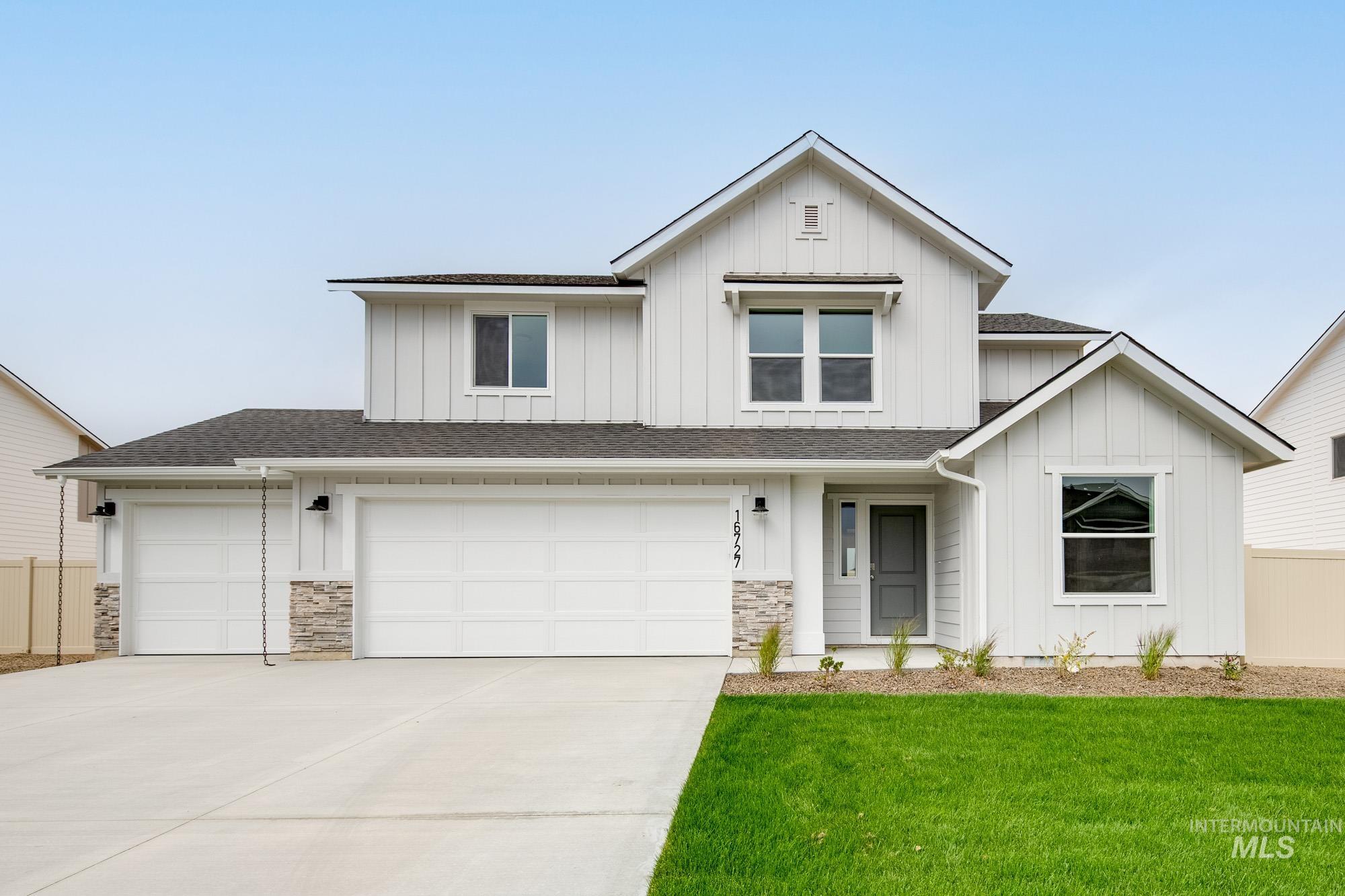 Modern farmhouse with board and batten siding, a shingled roof, concrete driveway, a garage, and stone siding