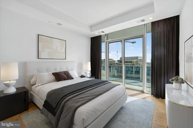a bedroom with a large bed and a balcony view
