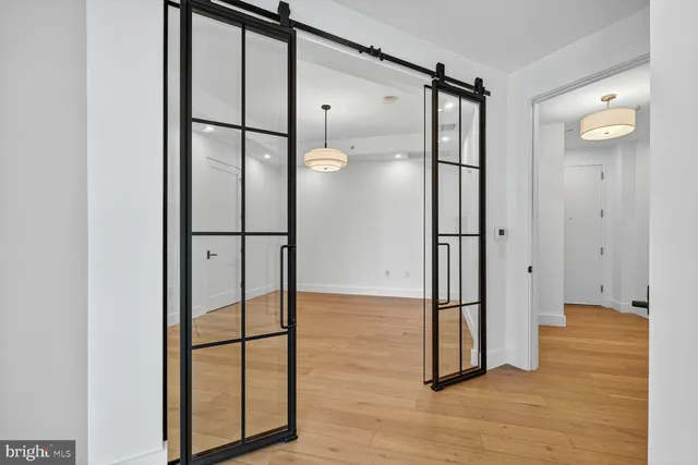 a bathroom with a glass shower door and mirror